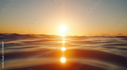 Fototapeta Naklejka Na Ścianę i Meble -  Sunrise over a hazy ocean.  Golden light reflects on rippling water