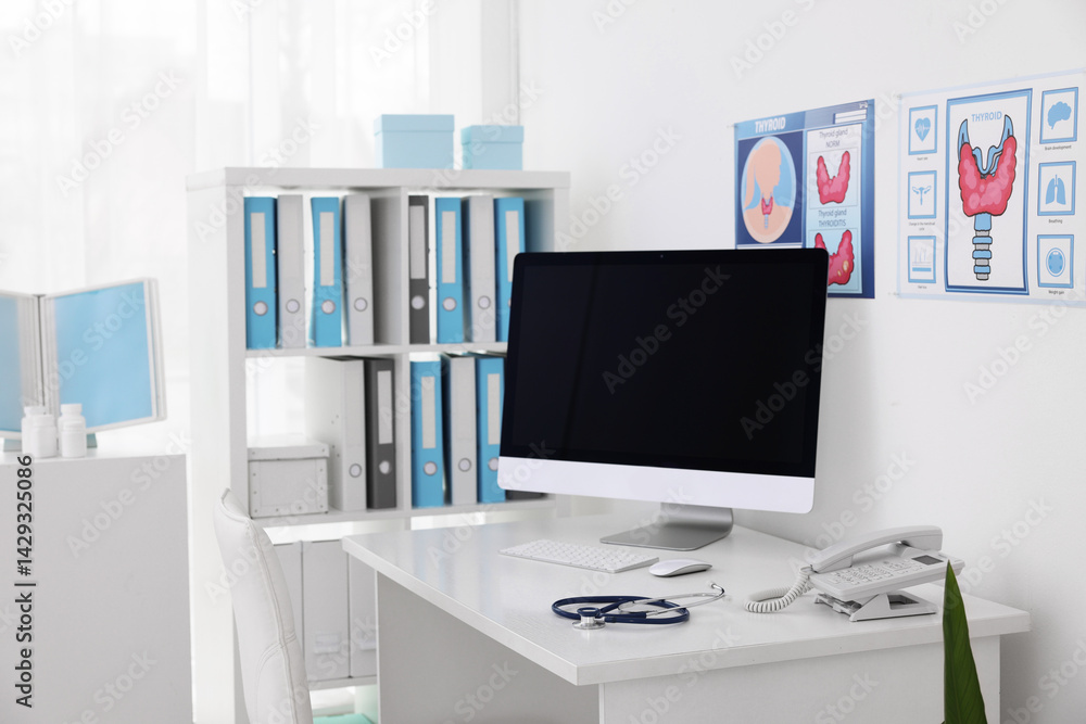 Fototapeta premium Clipboard, pen, computer, telephone and stethoscope on desk in doctor's office