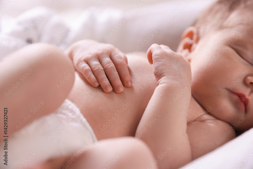 Little baby sleeping in bed indoors, closeup Little baby sleeping in bed indoors, closeup
