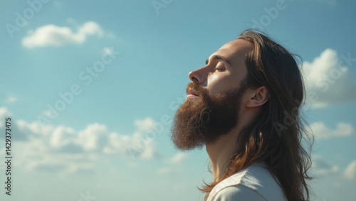 Obraz na płótnie Man with a beard is looking up at the sky. He is in a peaceful and contemplative mood w salonie