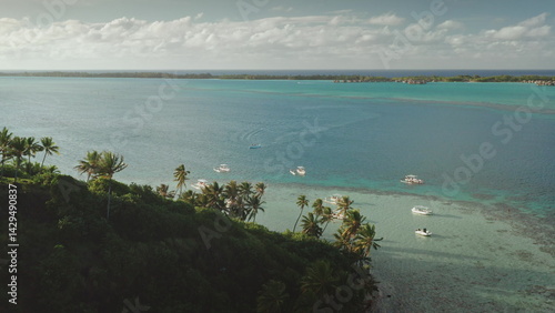 Obraz na płótnie Several boats are sailing on crystal-clear turquoise water near a lush tropical island coastline, creating a picturesque scene of leisure and exploration in a serene paradise w salonie