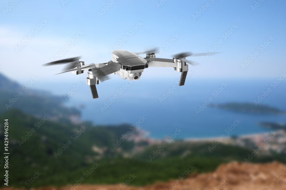 Drone with camera flying in mountains. Unmanned aerial vehicle for surveillance Drone with camera flying in mountains. Unmanned aerial vehicle for surveillance