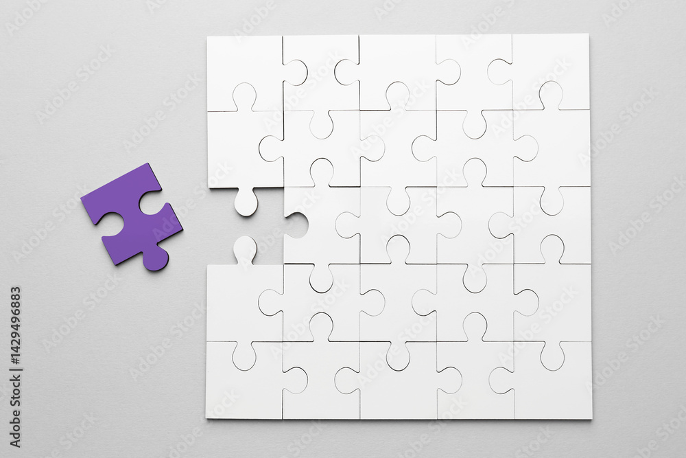 White puzzle with purple missing piece on light grey background, top view. Different, unique, special White puzzle with purple missing piece on light grey background, top view. Different, unique, special