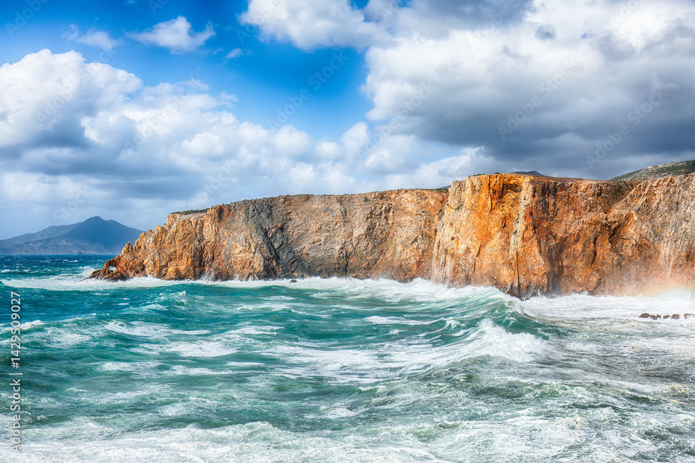 Attractive view of cliffs in valley Cala Domestica and storm on the sea