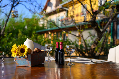 Decorative table with wine and sunflowers