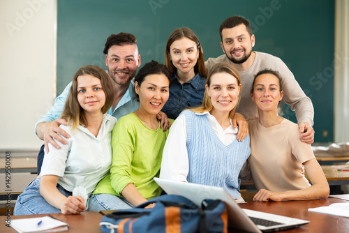 Group portrait of a positive group of young students in a university auditorium
