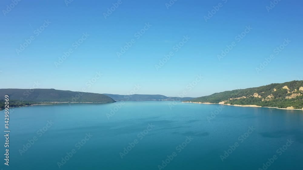 The mountains bordering the turquoise lake of Sainte-Croix in Europe, France, Provence Alpes Cote d Azur, in the Var, in summer, on a sunny day. The mountains bordering the turquoise lake of Sainte-Croix in Europe, France, Provence Alpes Cote d Azur, in the Var, in summer, on a sunny day.