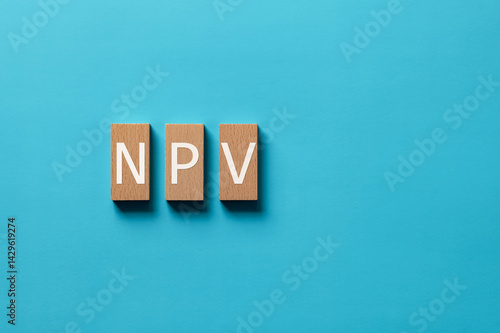 There is wood block with the word NPV. It is an abbreviation for Net Present Value as eye-catching image.
