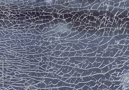 Obraz na płótnie Detail of broken tempered glass pane too many small irregular shape pieces holding together. Texture of cracked broken glass cracked by impact, Cracks on the glass surface background, Copy space. w salonie