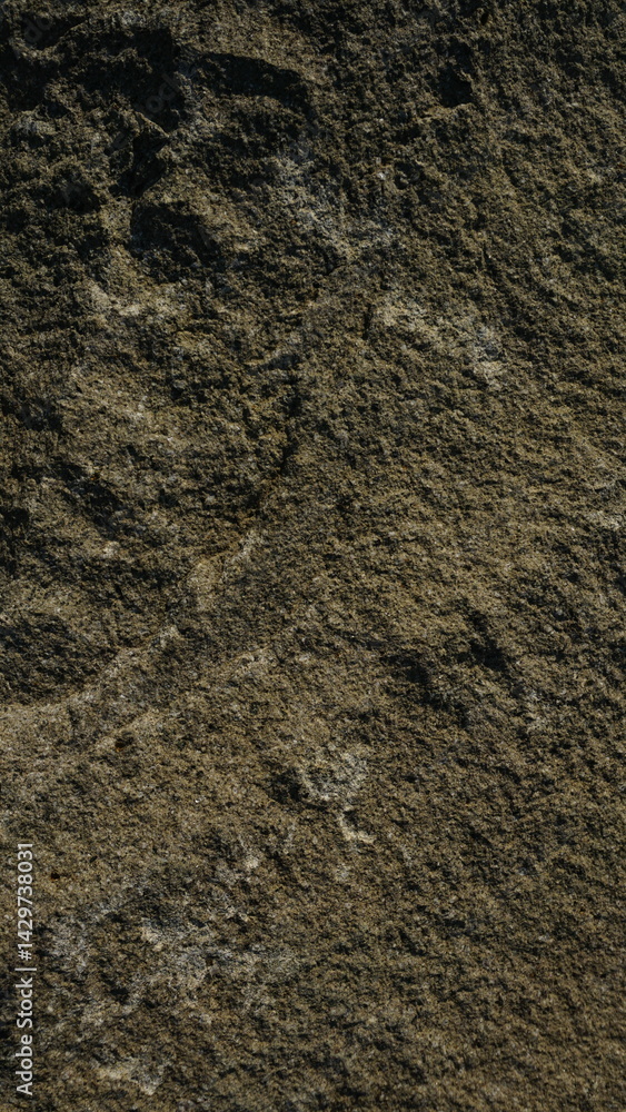 Close-up texture of rough, dark brown stone Close-up texture of rough, dark brown stone