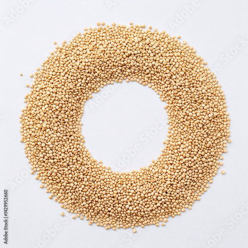 White quinoa seeds in circle form on white background. Top view