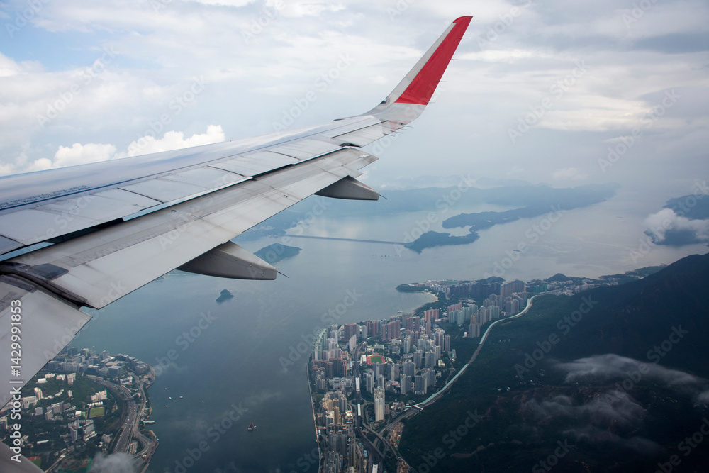 Obraz premium Aerial view landscape and cityscape of HongKong island from airbus flying from Bangkok to Hong Kong, China