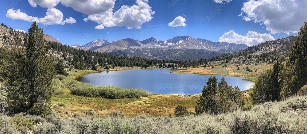 Naklejka premium Scenic landscape captures a peaceful mountain lake and surrounding nature