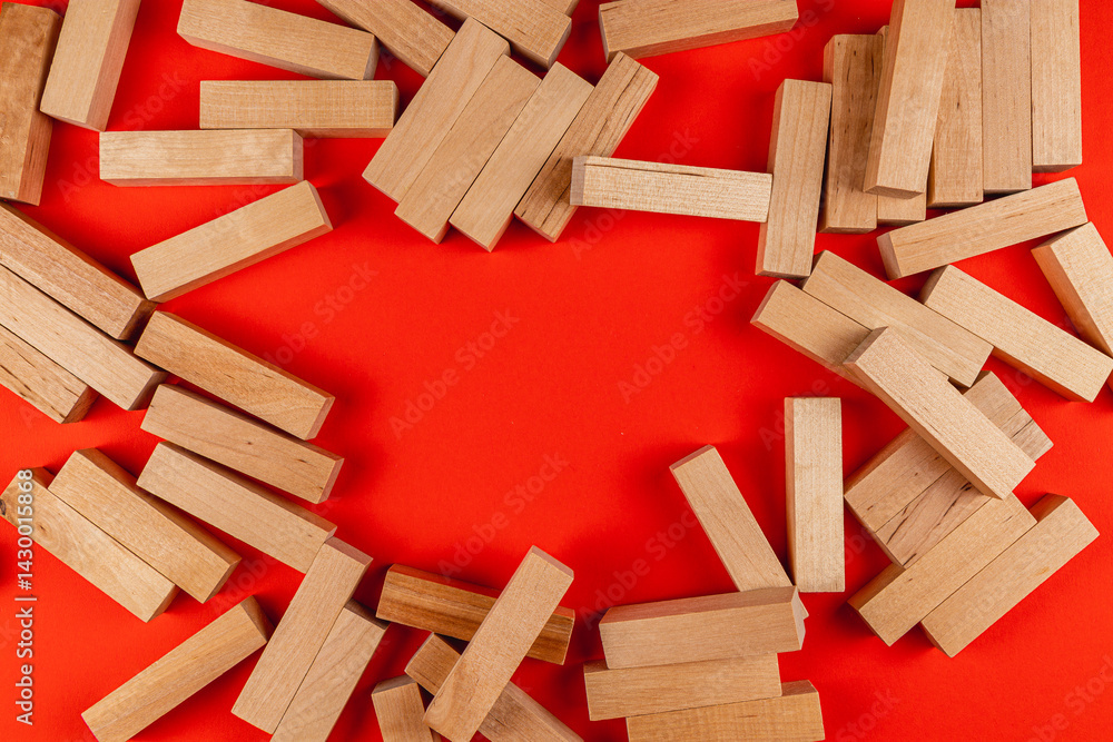 Wooden blocks scattered on vibrant red background