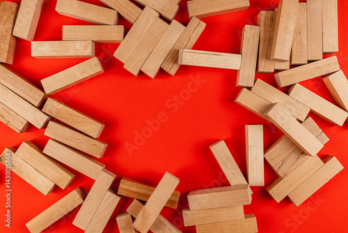 Obraz na płótnie Wooden blocks scattered on vibrant red background w salonie
