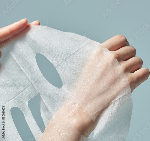 A woman's hand on a mask sheet