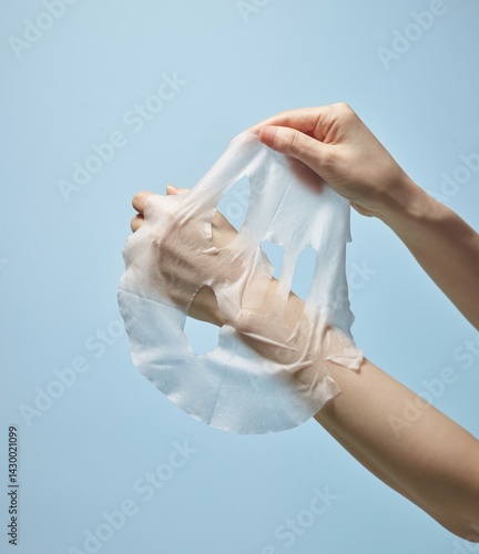 A woman's hand on a mask sheet