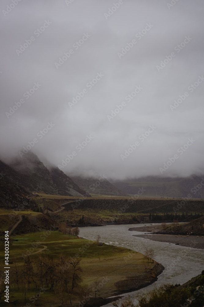 Fototapeta premium Foggy landscape with river in mountains