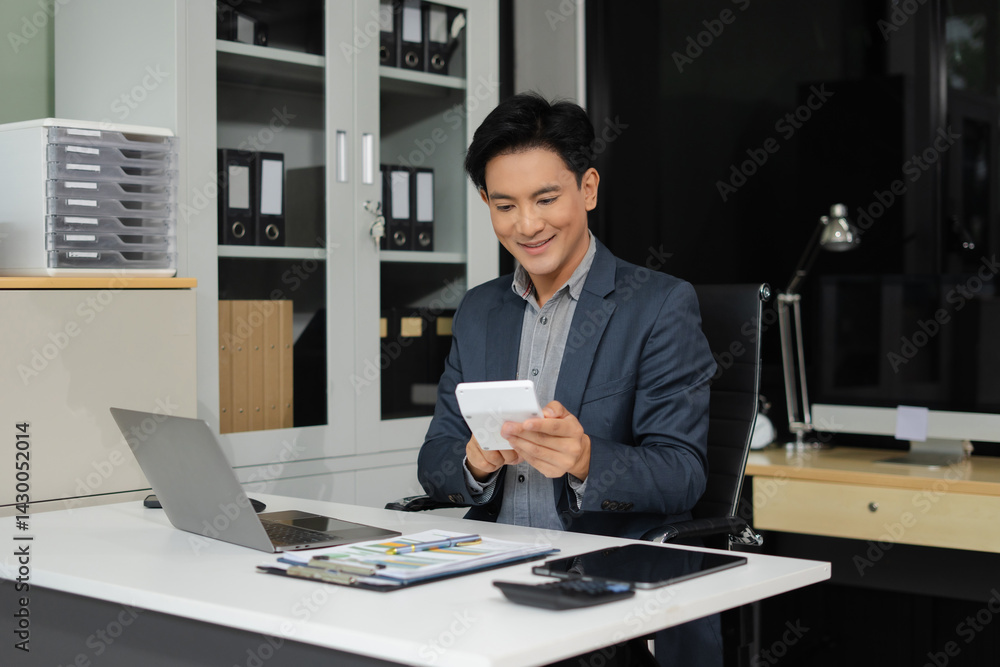 Male businessman working on desk office with using a calculator to calculate the numbers. Male businessman working on desk office with using a calculator to calculate the numbers.