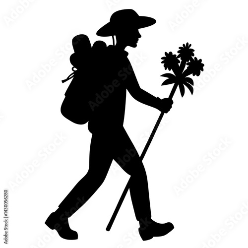 Silhouette of hiker with backpack and staff