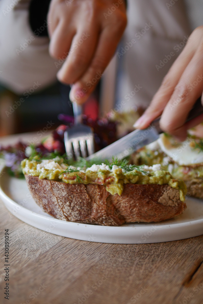 Enjoying fresh avocado toast at a cozy cafe in the morning Enjoying fresh avocado toast at a cozy cafe in the morning