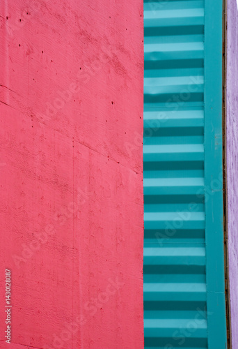 abstract vertical background backdrop image of close cropped smooth red and corrugated turquoise containers small strip of purple on right side colorful divided columns with blank red space for type 