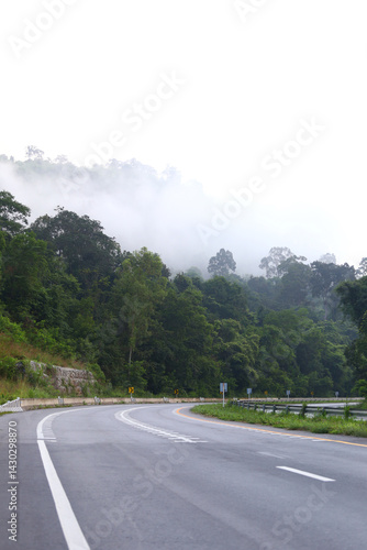Obraz na płótnie Empty road cutting through the mountains road and there was mist in the morning. w salonie