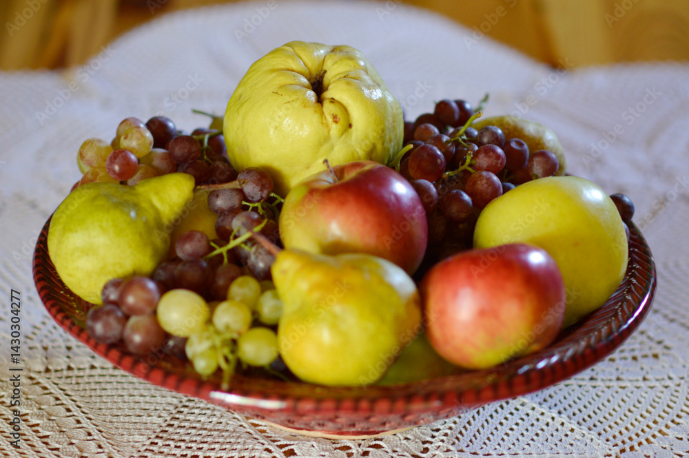 ceramic bowl with various ripe fruits at the table