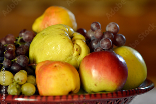 Obraz na płótnie ceramic bowl with various ripe fruits at the table w salonie