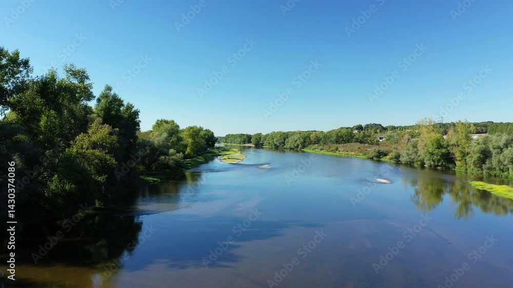 The Loire and its green vegetation in summer in Europe, in France, in Burgundy, in Nievre, in summer, on a sunny day. The Loire and its green vegetation in summer in Europe, in France, in Burgundy, in Nievre, in summer, on a sunny day.