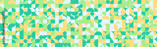 Vibrant geometric pattern featuring a playful mix of circles, squares, and semicircles in pastel greens, yellows, and whites.