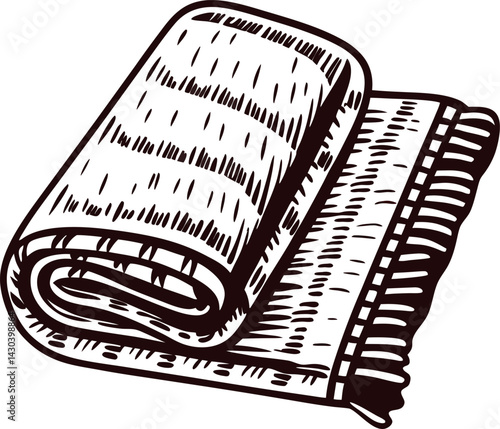 Detailed of a folded blanket draped with tassels in black and white design.