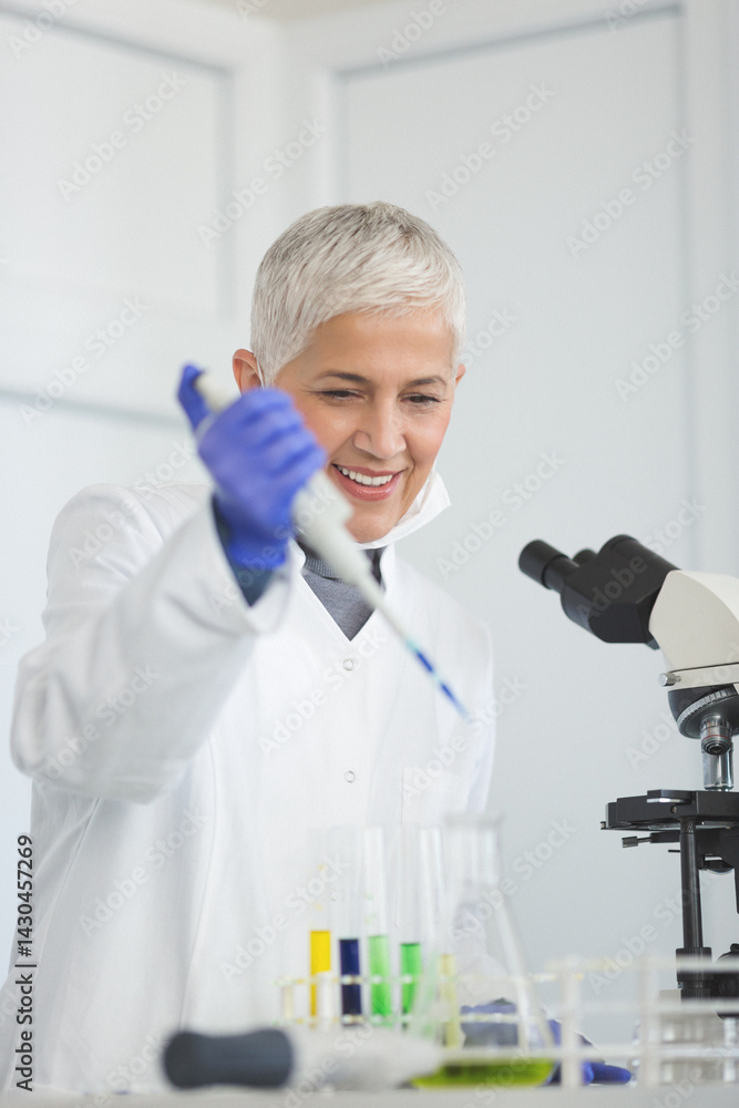 Senior female scientist working in laboratory Senior female scientist working in laboratory