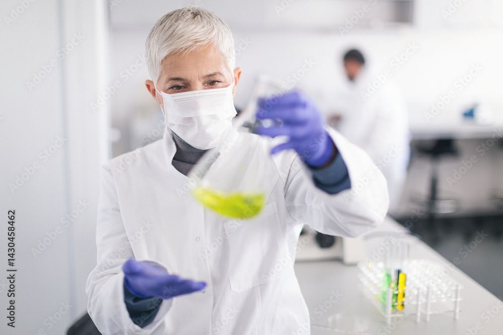 Senior female scientist working in laboratory Senior female scientist working in laboratory