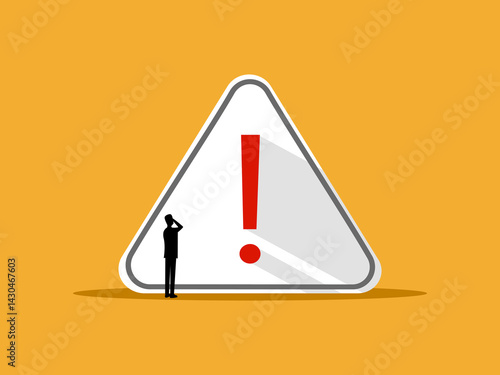 Alert and caution concept, businessman at warning sign.