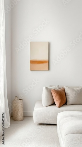 Bright contemporary den seating area featuring minimal decor and a small painting on the wall above a cozy sofa in neutral tones