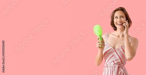 Young woman with mini fan t...