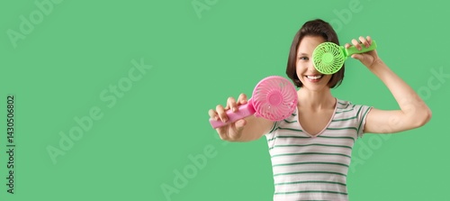 Young woman with mini fans ...