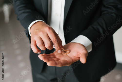 Groom Presenting Wedding Rings On Palm