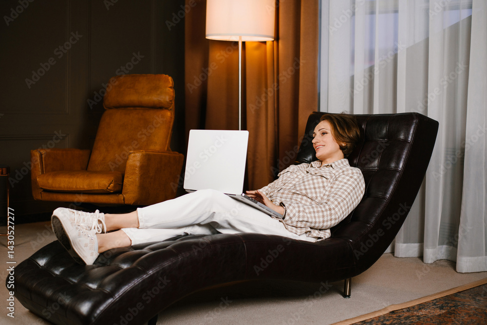 Smiling Woman Working On Laptop In Therapy Office