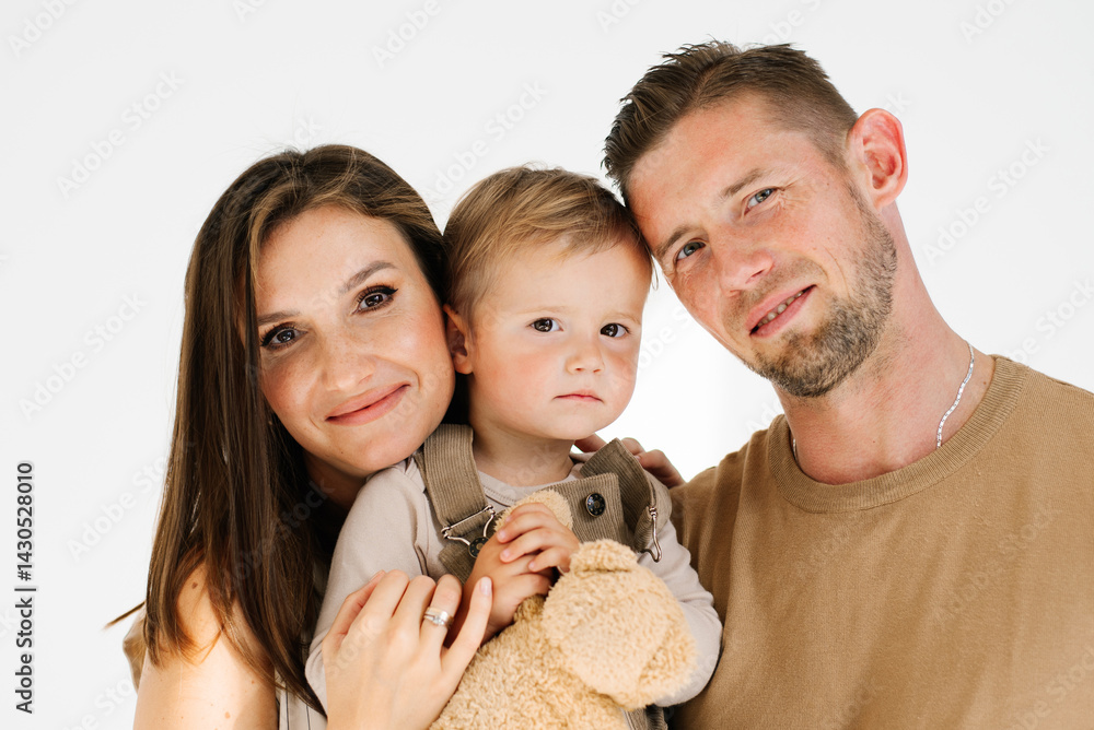 Caucasian young family with a young son in their arms Caucasian young family with a young son in their arms