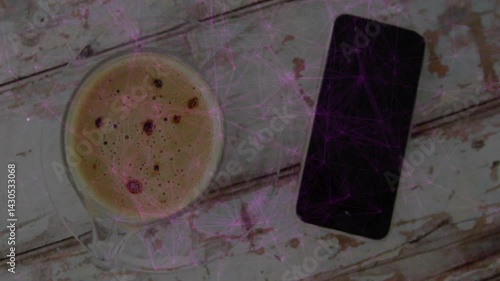 espresso cup being placed on weathered wooden table, showing black smartphone beside glass saucer