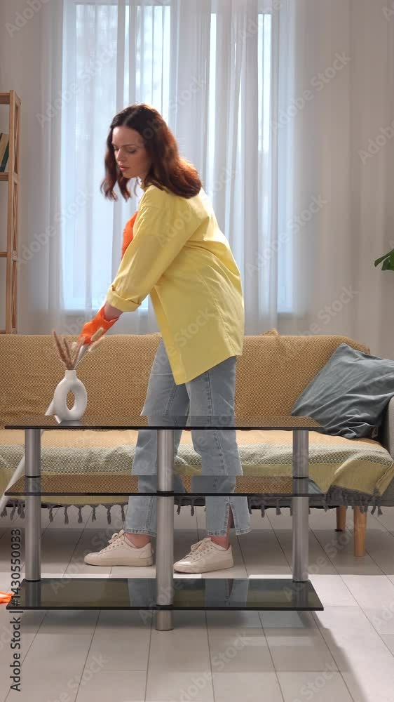 Young adult woman spending time at home, housekeeping time on weekend, woman in the living room mopping the floor with mop, tired expression. Young adult woman spending time at home, housekeeping time on weekend, woman in the living room mopping the floor with mop, tired expression.