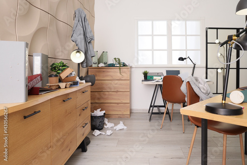 Fotografija Interior of messy office with drawers, desks and garbage