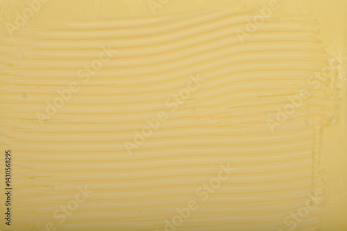 Obraz na płótnie A tightly cropped, top-down shot shows the textured surface of a block of pale yellow butter w salonie