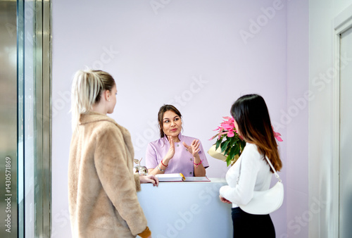 Beauty Salon Receptionist Assisting Clients in Modern Lobby