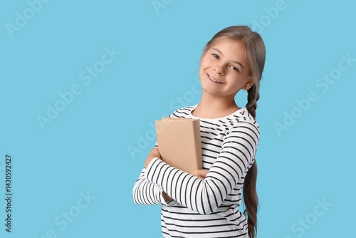 Cute schoolgirl with book o...