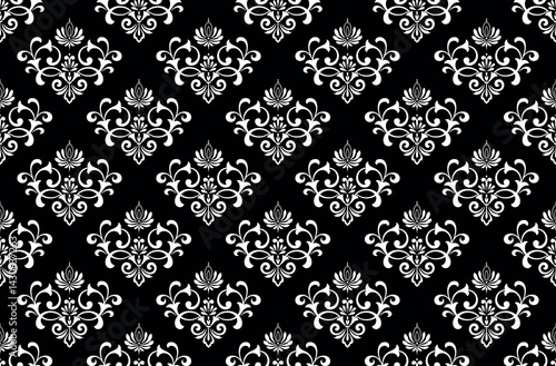 Wallpaper in the style of Baroque. White and black floral ornament. Seamless vector background. Graphic pattern for fabric, wallpaper, packaging. Ornate Damask flower illustration.