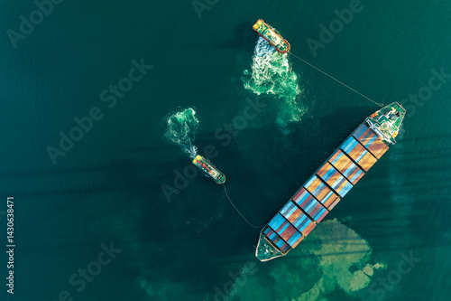Top view of a large cargo ship loading and unloading containers at a deep-sea port. This aerial scene highlights global logistics, international trade, and maritime transportation hubs.