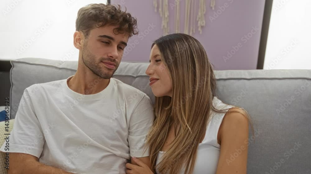 Couple embracing on a cozy sofa in a beautifully lit living room, showcasing warmth and connection with love in a modern home setting. Couple embracing on a cozy sofa in a beautifully lit living room, showcasing warmth and connection with love in a modern home setting.